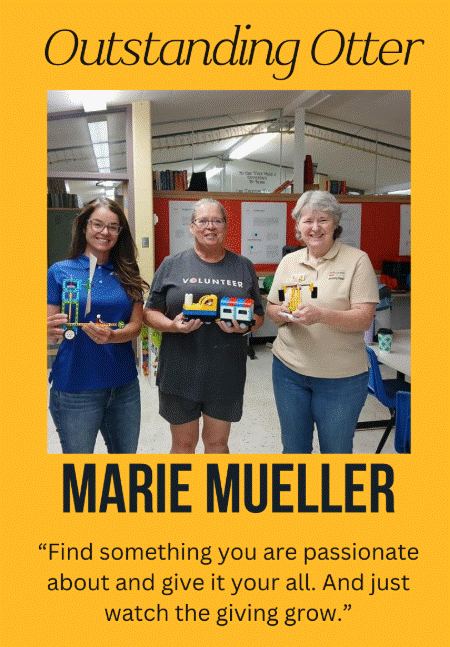 Marie, center, holds two models that were built by teachers while learning from Laura Jackson, Lego Education trainer, about the Lego Education curriculum and how to use it with their students to learn through play.